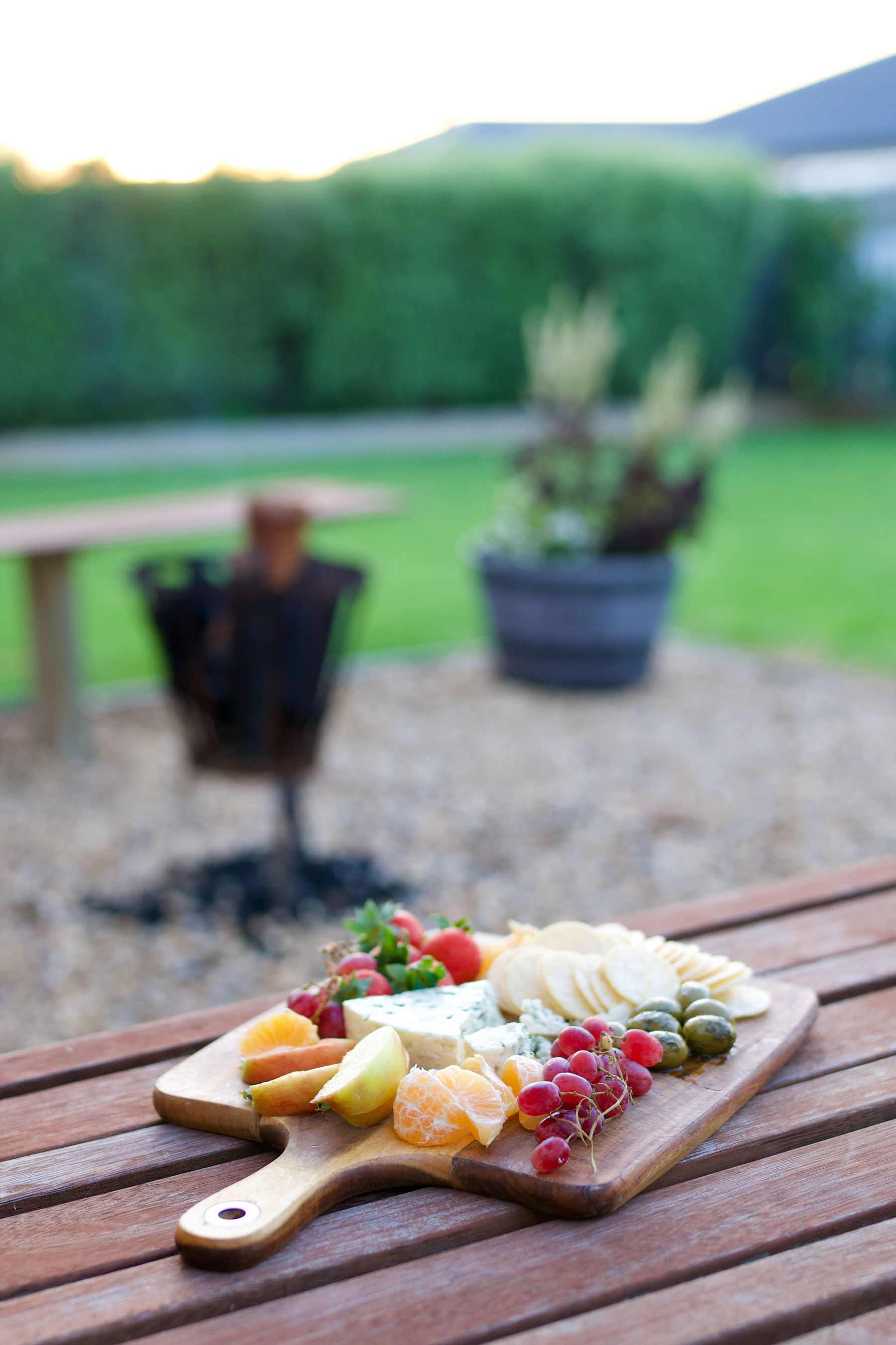 Cheese board beside the firepit at dusk