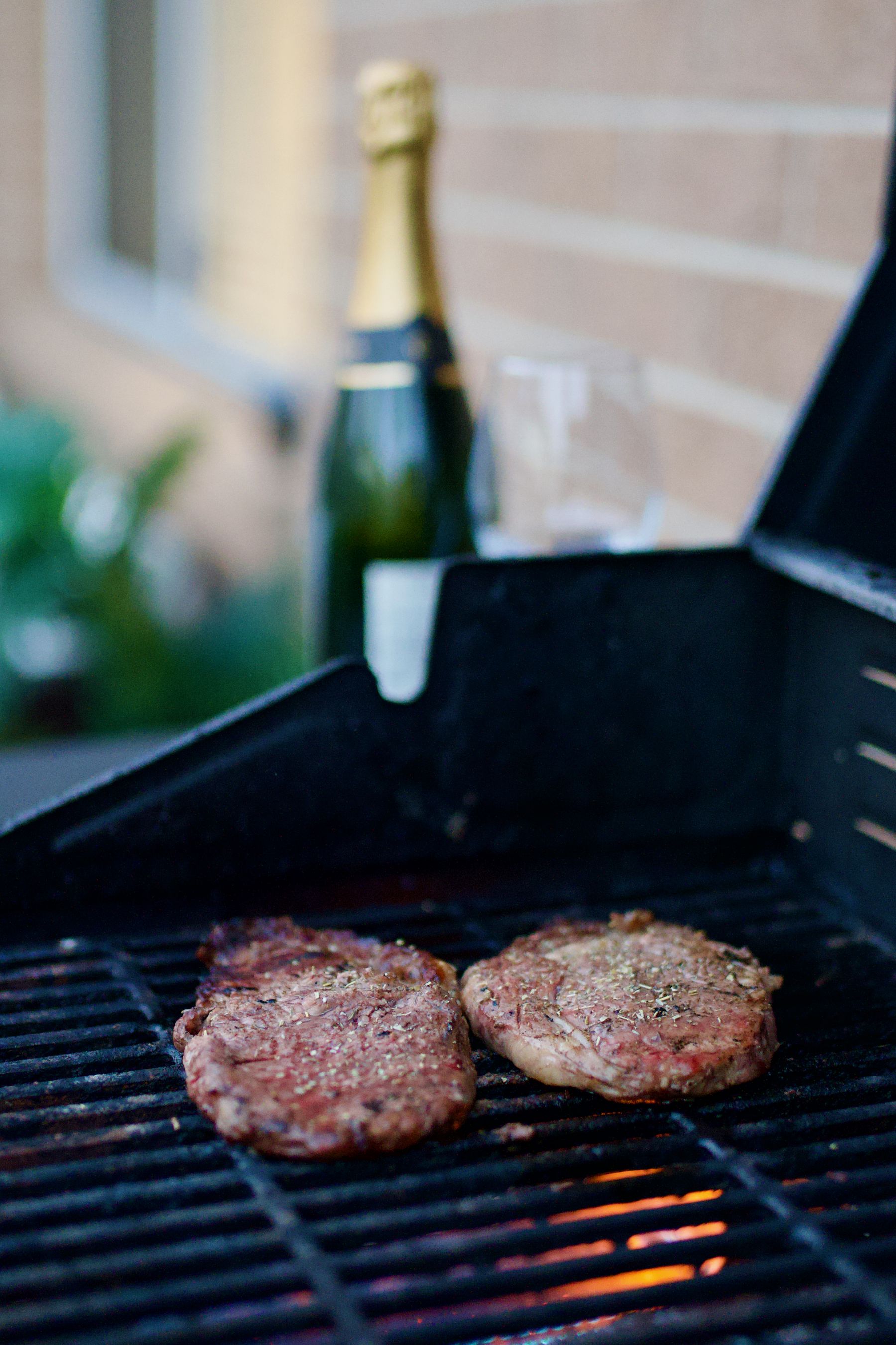 Champagne and patties on the barbecue