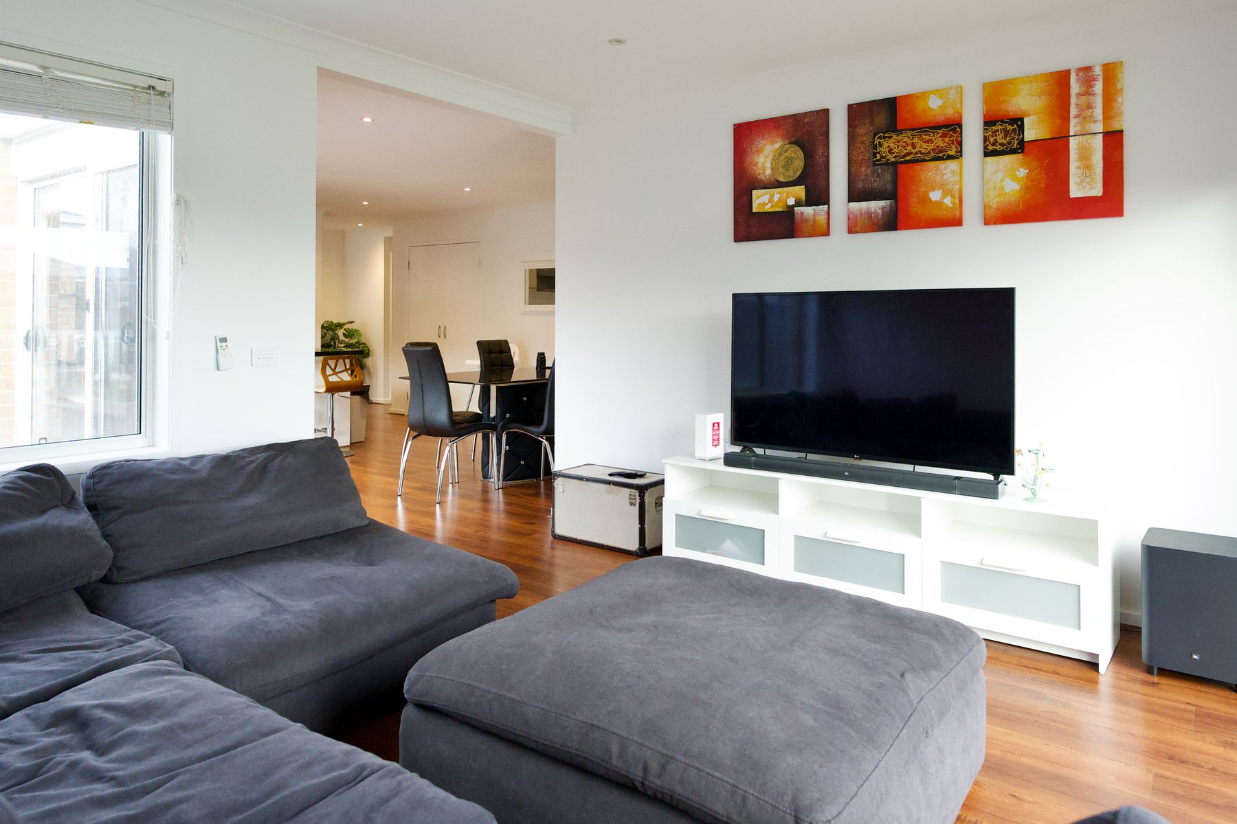 Living room with television and artwork
